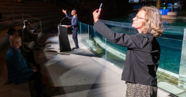 a man in a podium exposing to a crowd
