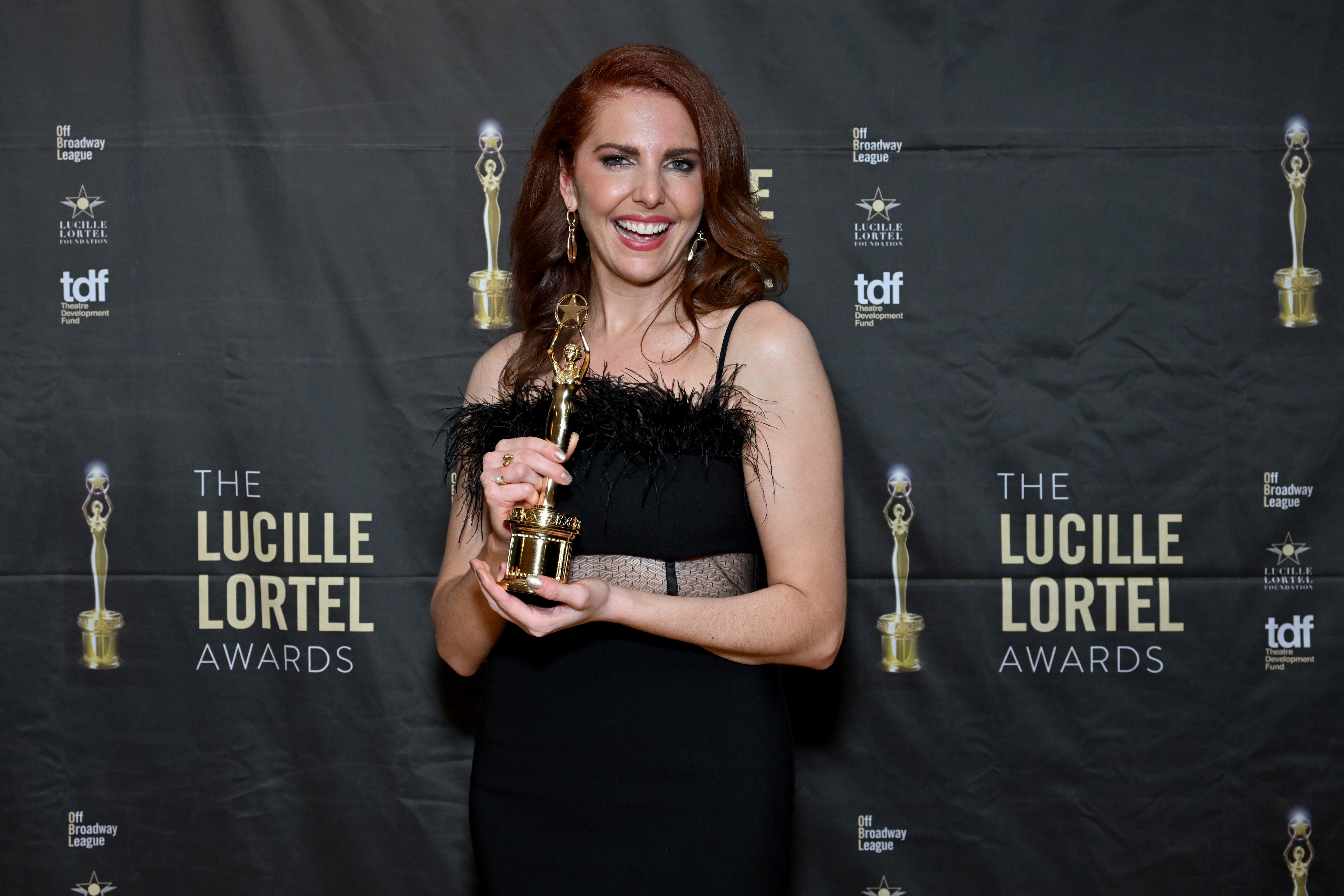 Marla Mindelle poses with an award in the press room during the 38th Annual Lucille Lortel Awards at NYU Skirball Center