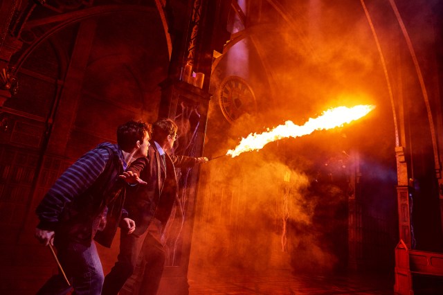 09 HPCC NY YearFive HarryAlbusBattle with Meyers Haggard PhotoByMatthewMurphy Two wizards stage onstage as one shoots flames out of his wand.