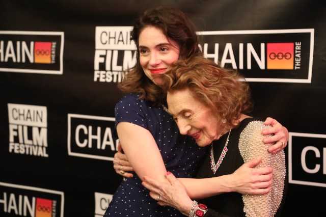 Masha King and Helena Weinrauch Opening Night, Photo by David Zayas Jr. Two woman embrace in front of a step-and-repeat.