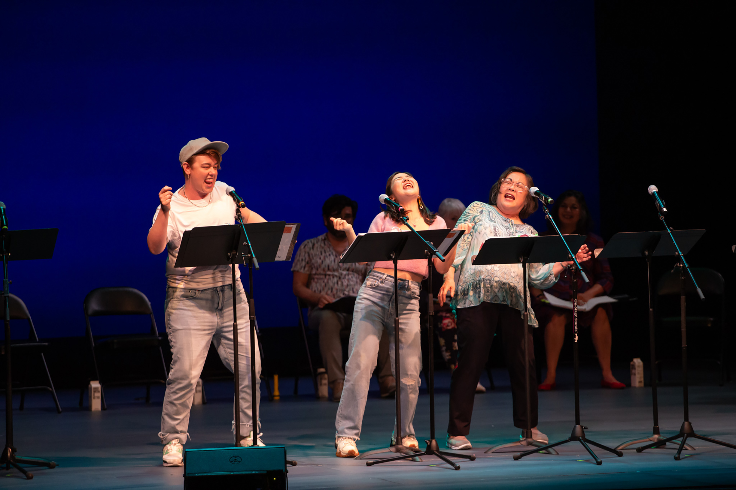 (l to r) Ezra Reaves, Claire Kwon, and Emily Kuroda in a reading of Happy Pleasant Valley: A Senior Sex Scandal Murder Mystery Musical (© Reed Flores)