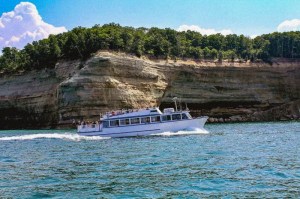 Grand Island Boat in front of cliffs